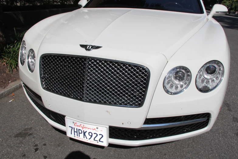 the front end of a white bentley mulsannen