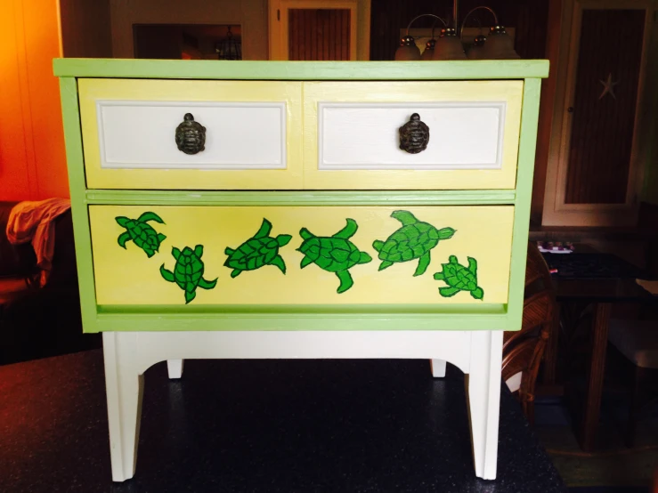 an old dresser with green and white drawers