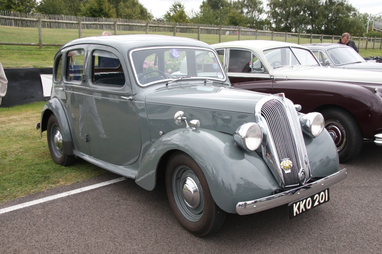 an old model car parked next to another one