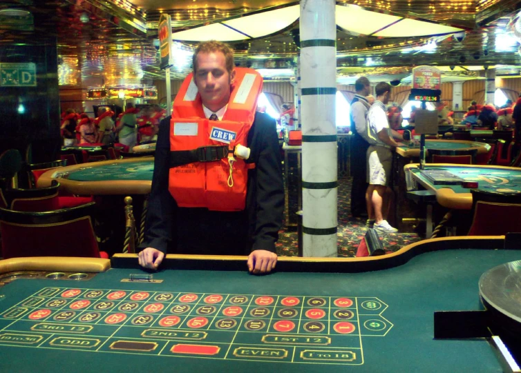 a man standing in front of a roule playing the roule on a gaming table