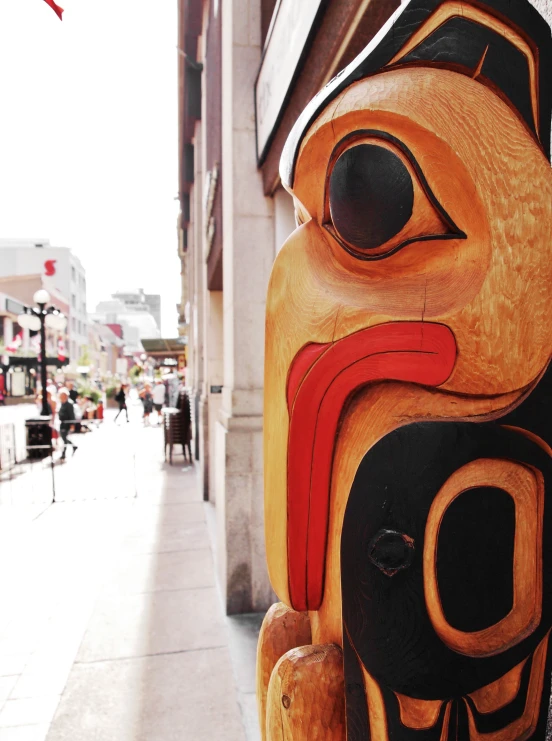 a wooden carving is shown at an outdoor event