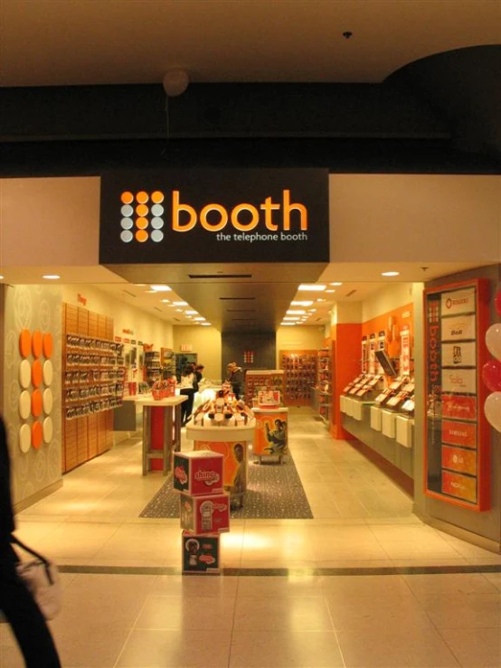 a booth in a mall with a person walking past it