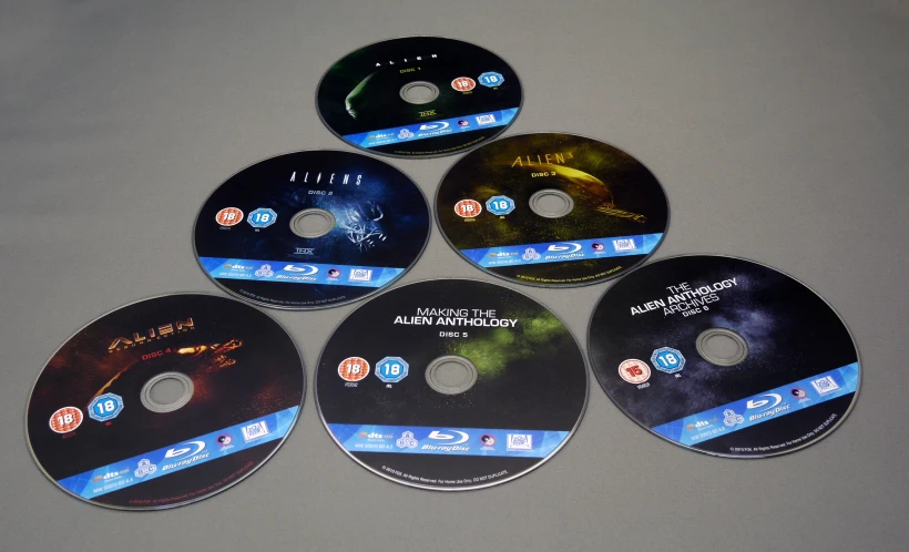 four dvd discs with different pictures in them