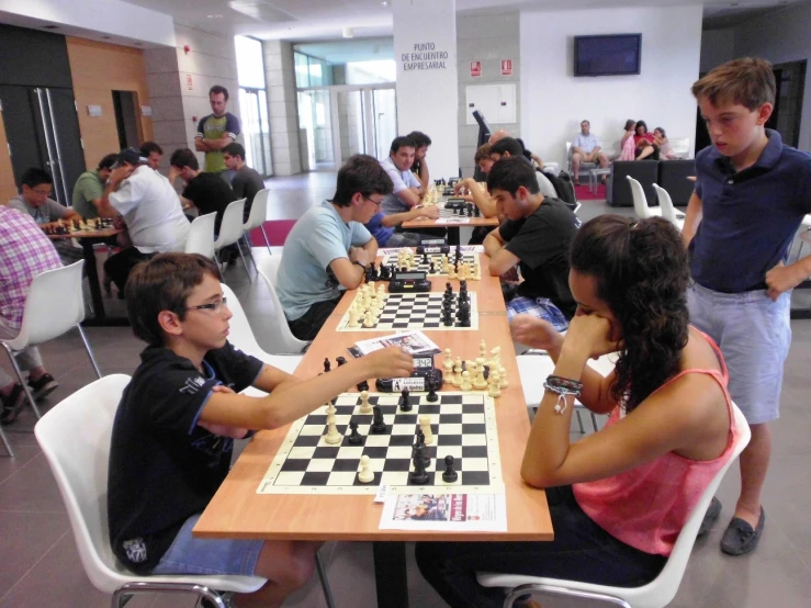 people playing chess in the middle of the room