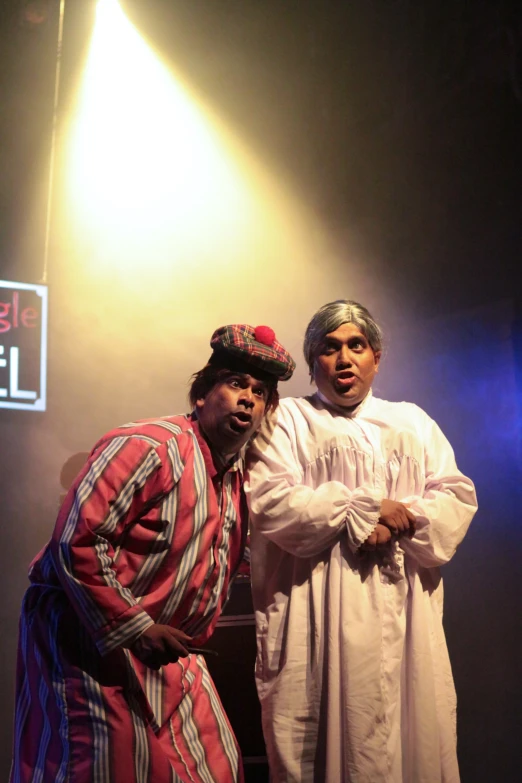 two people in costume posing on stage for a po