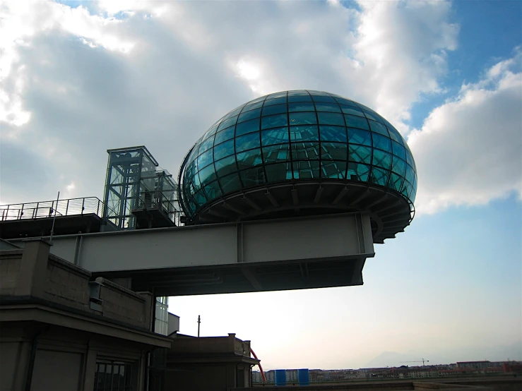 a large blue ball sitting on top of a bridge