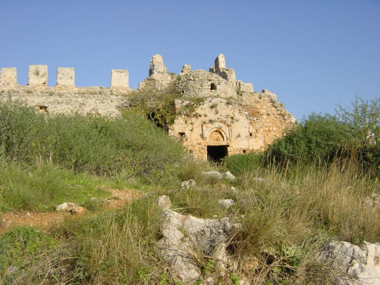 the ruins and trees in front of an old castle