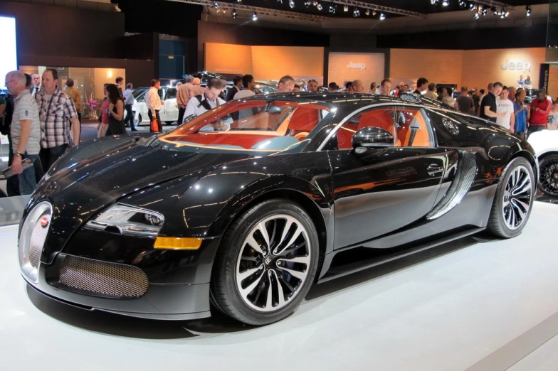 a bugatti type car parked on display in a showroom