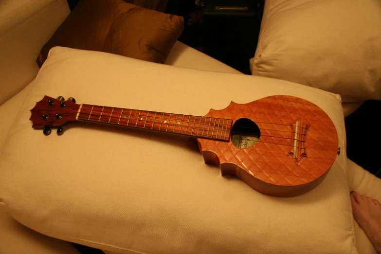a small wooden instrument on a pillow on the couch