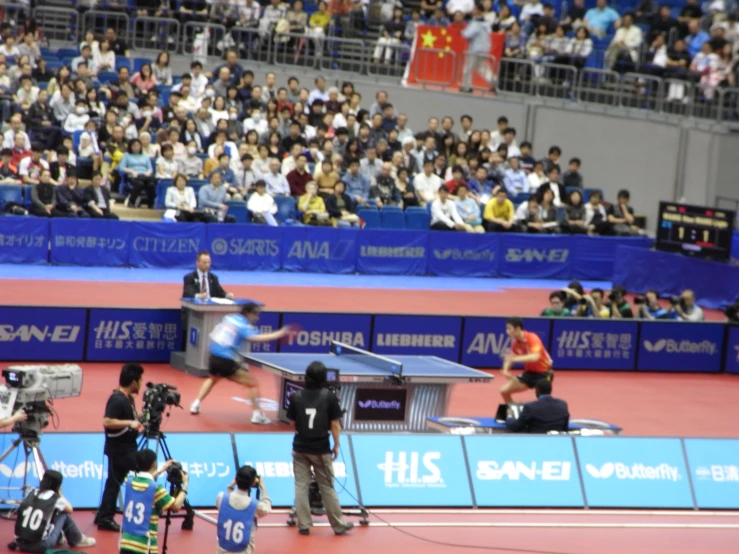 a man playing tennis on top of a tennis court