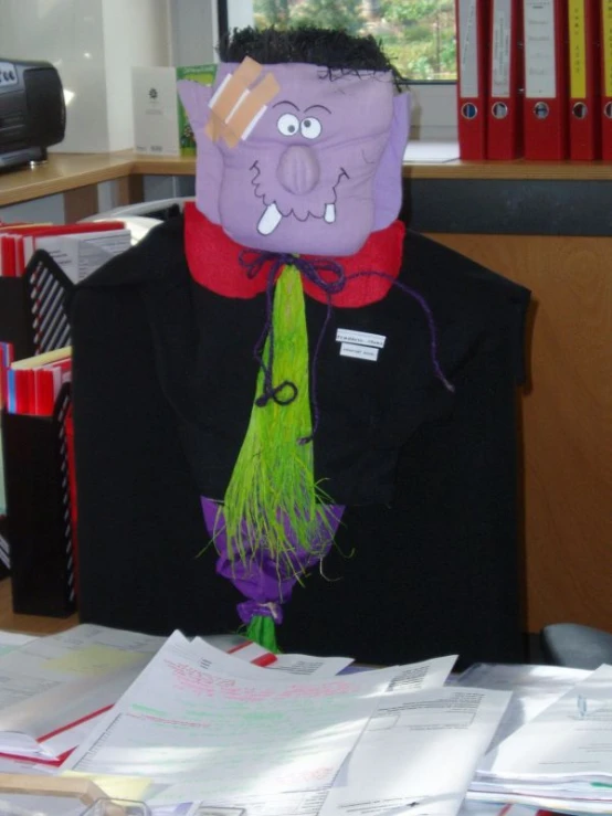 this man is wearing a mask while sitting at his desk