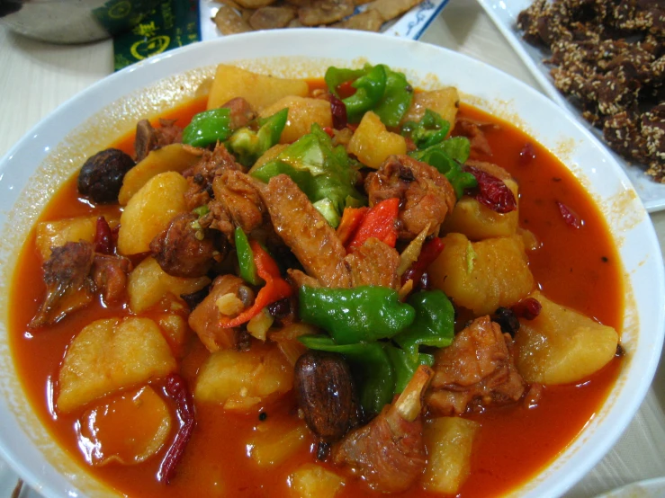 a bowl filled with meat, vegetables and sauce