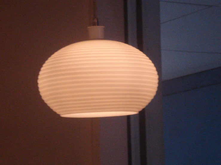 a white light hanging from a ceiling