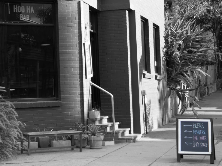 a black and white image of a restaurant with a sign for each