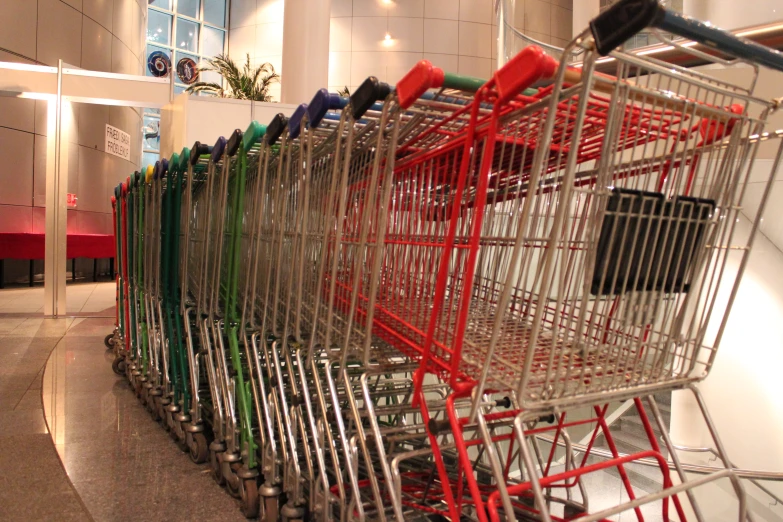 a row of shopping carts sitting in front of a building