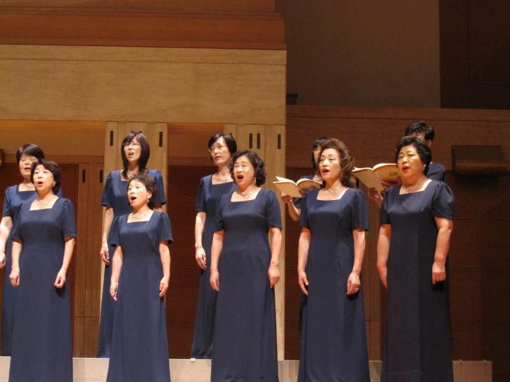 women singing on stage together at an event