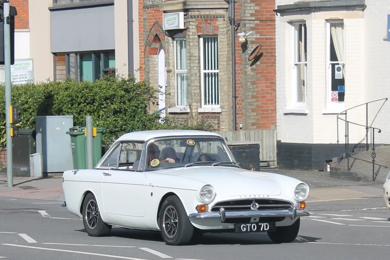 a classic car parked on the side of the road