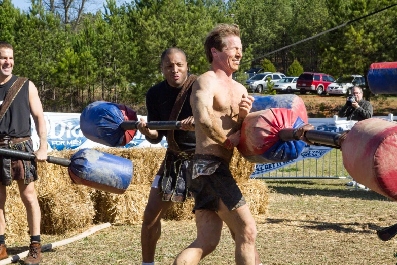 two men with boxing gloves are fighting in the grass