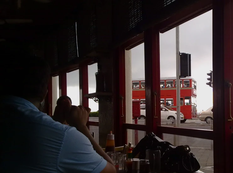 people sit and talk at a table on a rainy day