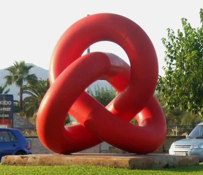 an inflatable piece sits on the ground with a red spiral