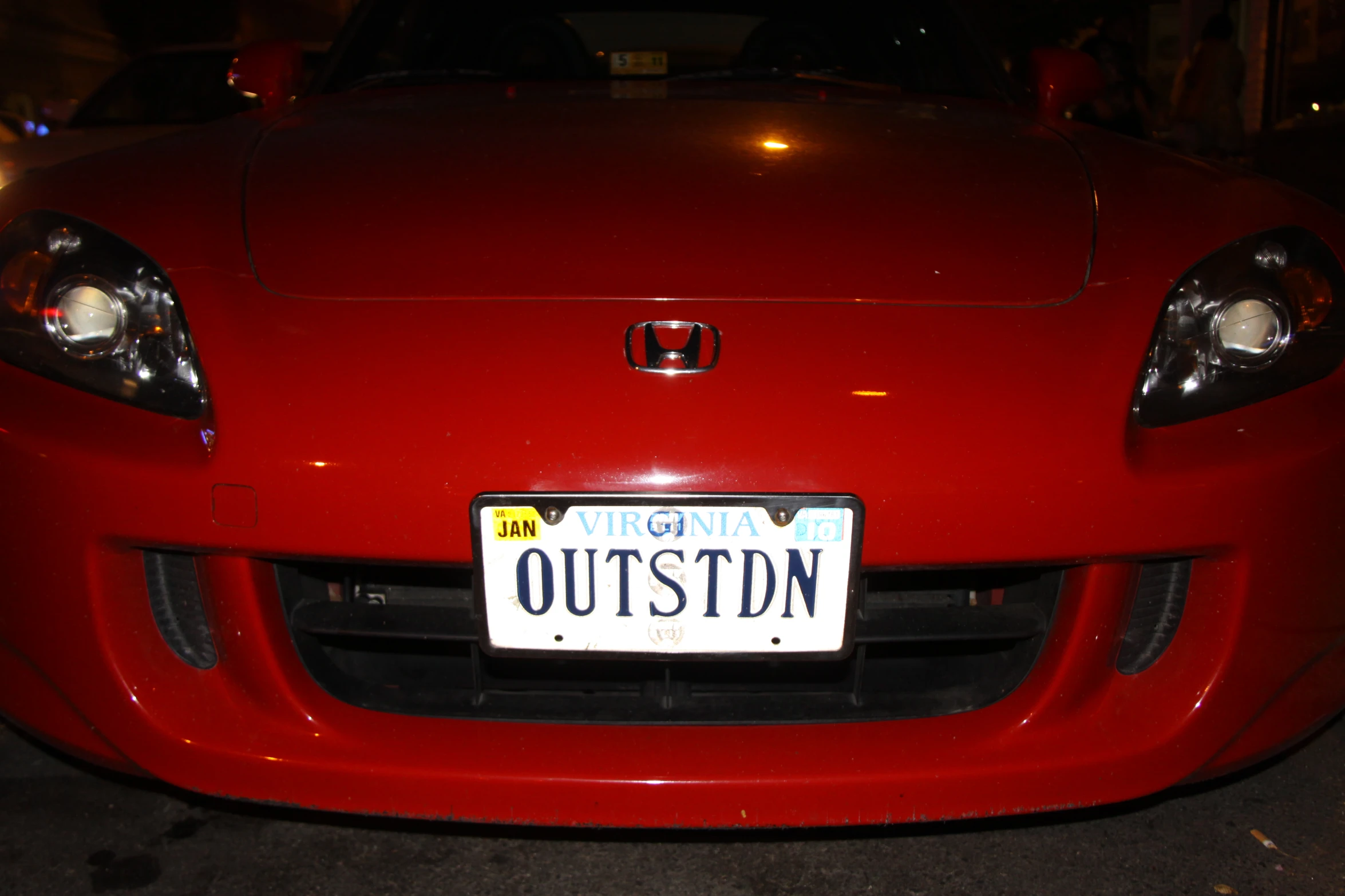 a license plate attached to a red car