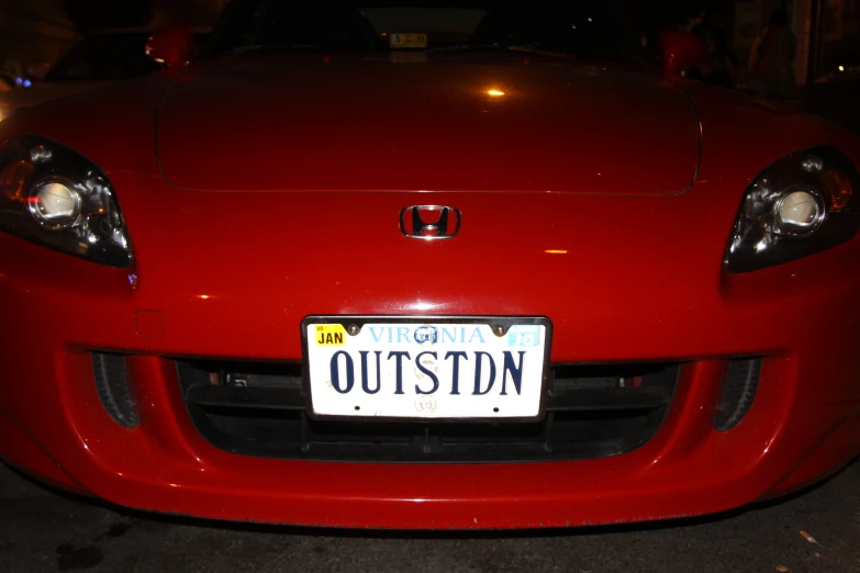 a license plate attached to a red car