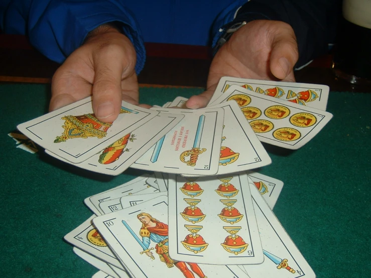 a person holding a deck of playing cards