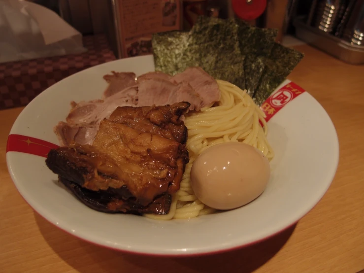 a plate of food that has meat and noodles