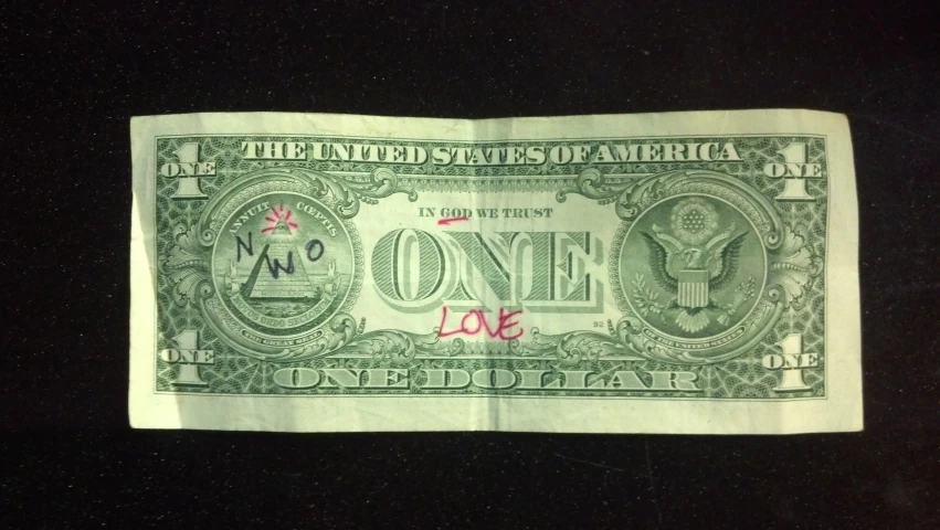 one dollar bill with the word love written on it