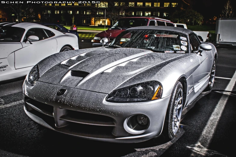 a sports car in front of some other cars