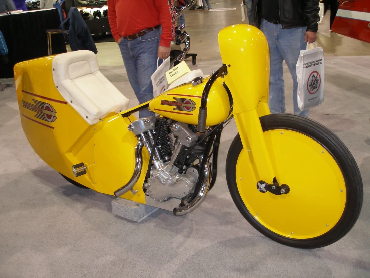 a yellow motorcycle with black and white stripes on it