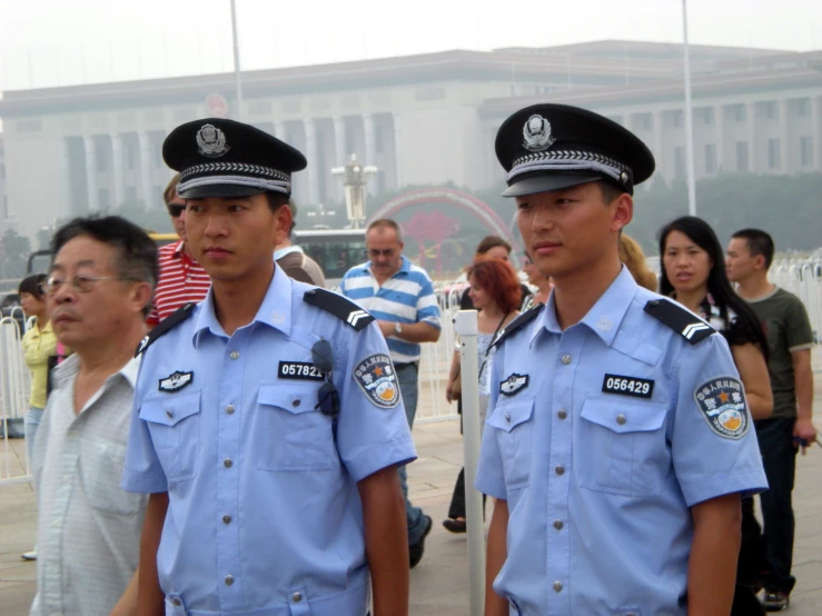 two male police officers in front of people