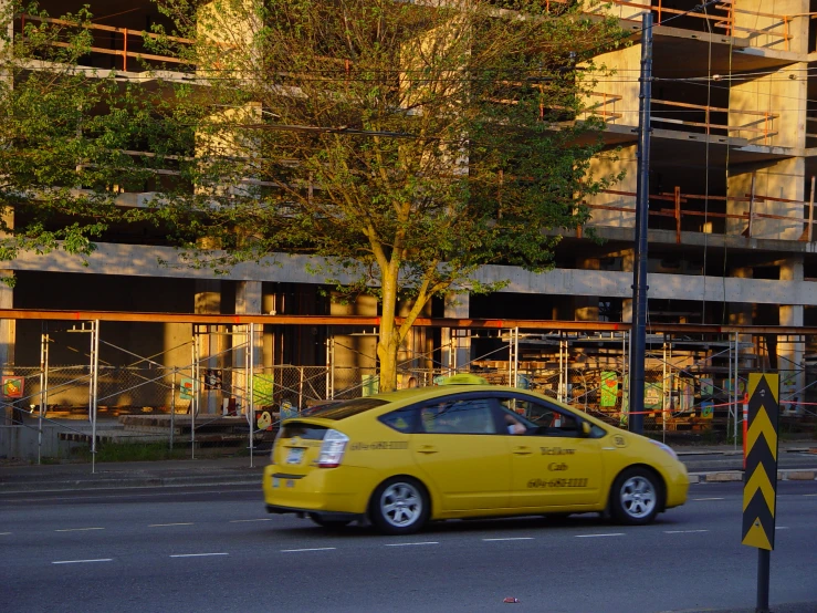 a car driving down the street in front of a building