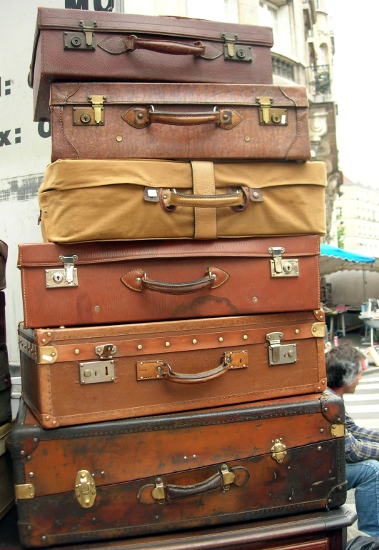 a stack of luggage sitting next to another stacked box