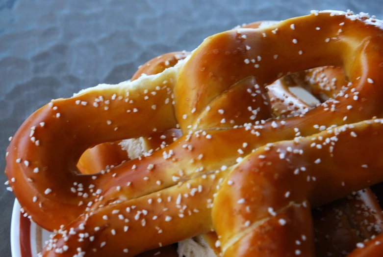 a plate with pretzels covered in sesame seeds