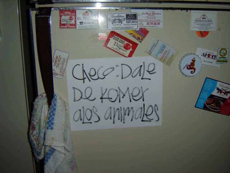 a sign that saysgrego de home y los amimos hangs from a refrigerator