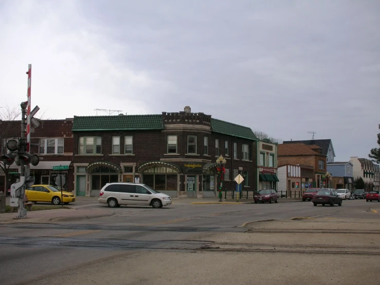 several cars at an intersection on a cloudy day