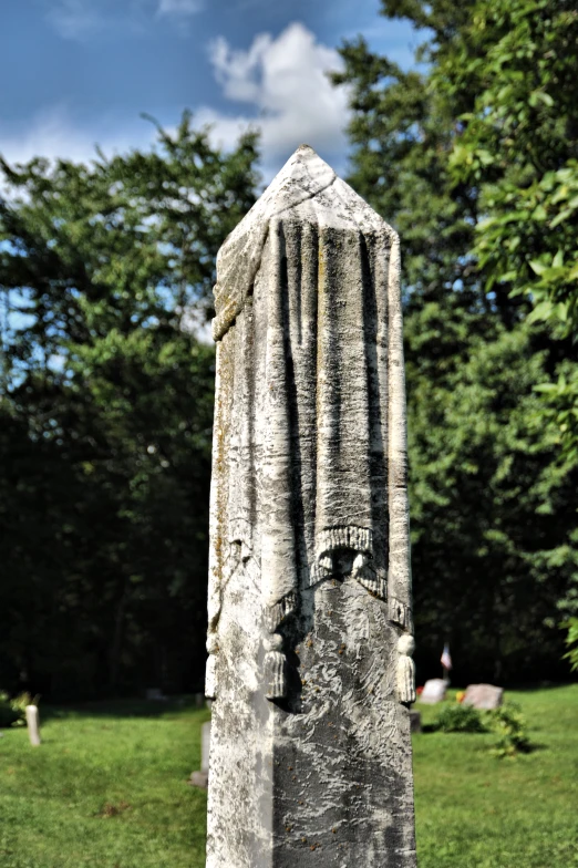 a large carved monument in a grassy area