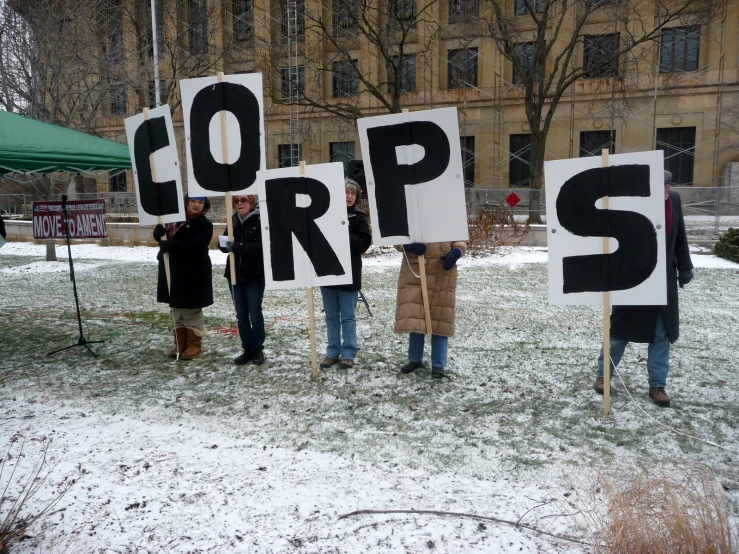 the protestors hold signs that say cop up