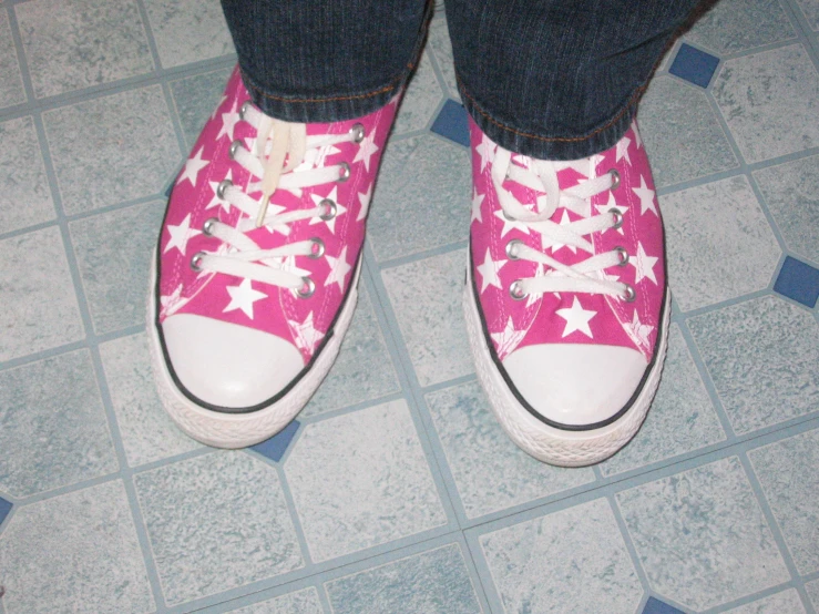 woman's pink shoes with stars on them on the floor