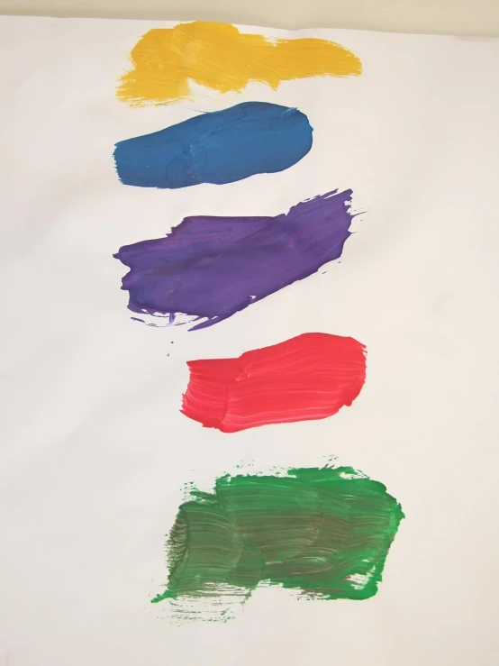 three strokes of different colors painted on paper