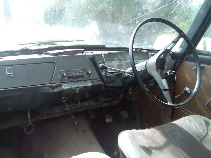 a dashboard of a car and a seat with a steering wheel