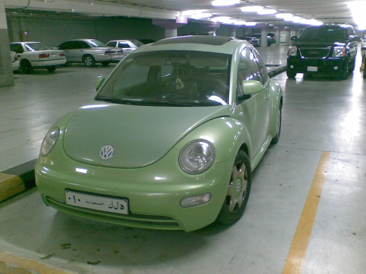 two cars parked in the same spot in a parking garage