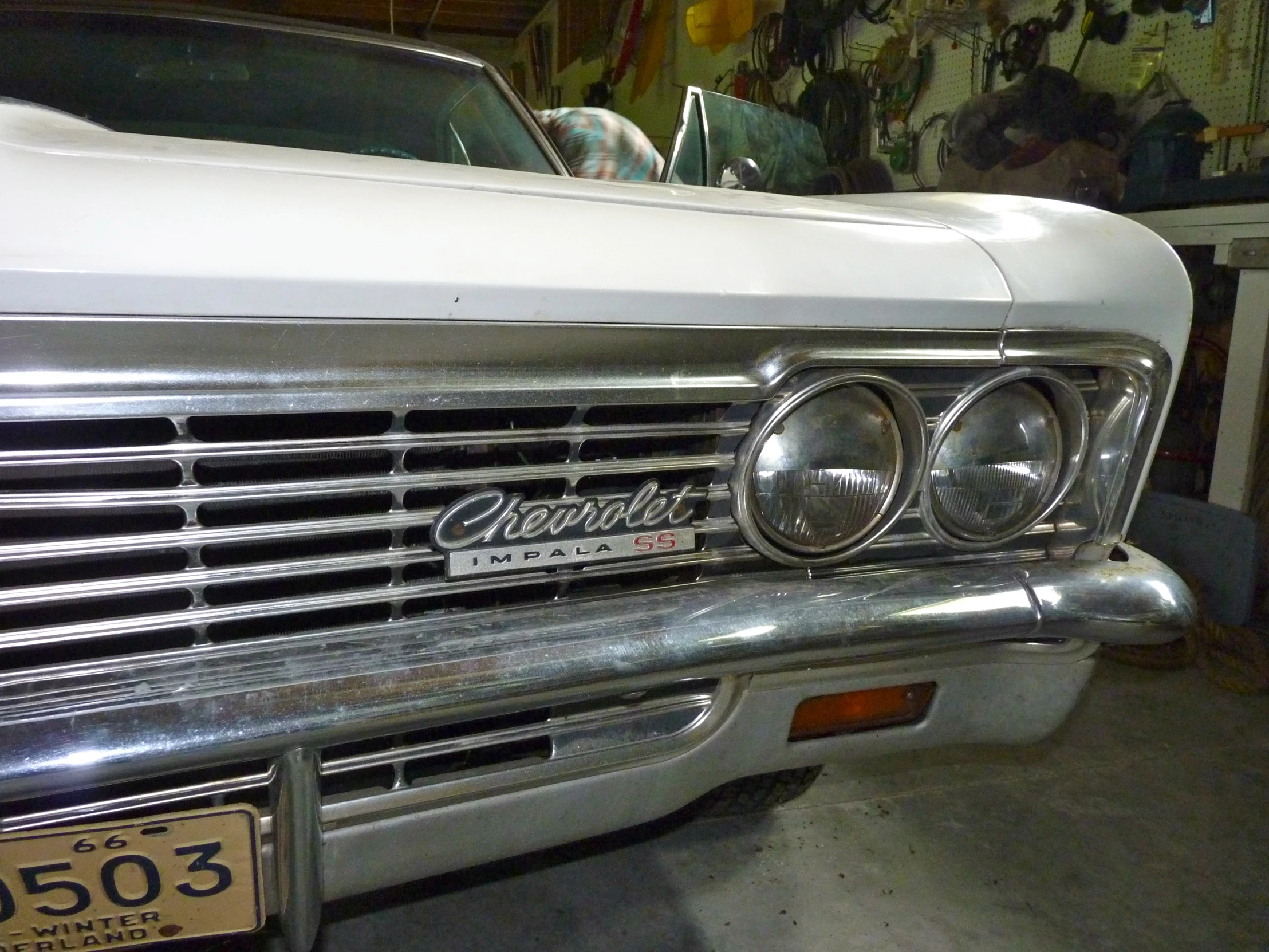 an old white car in the garage at night