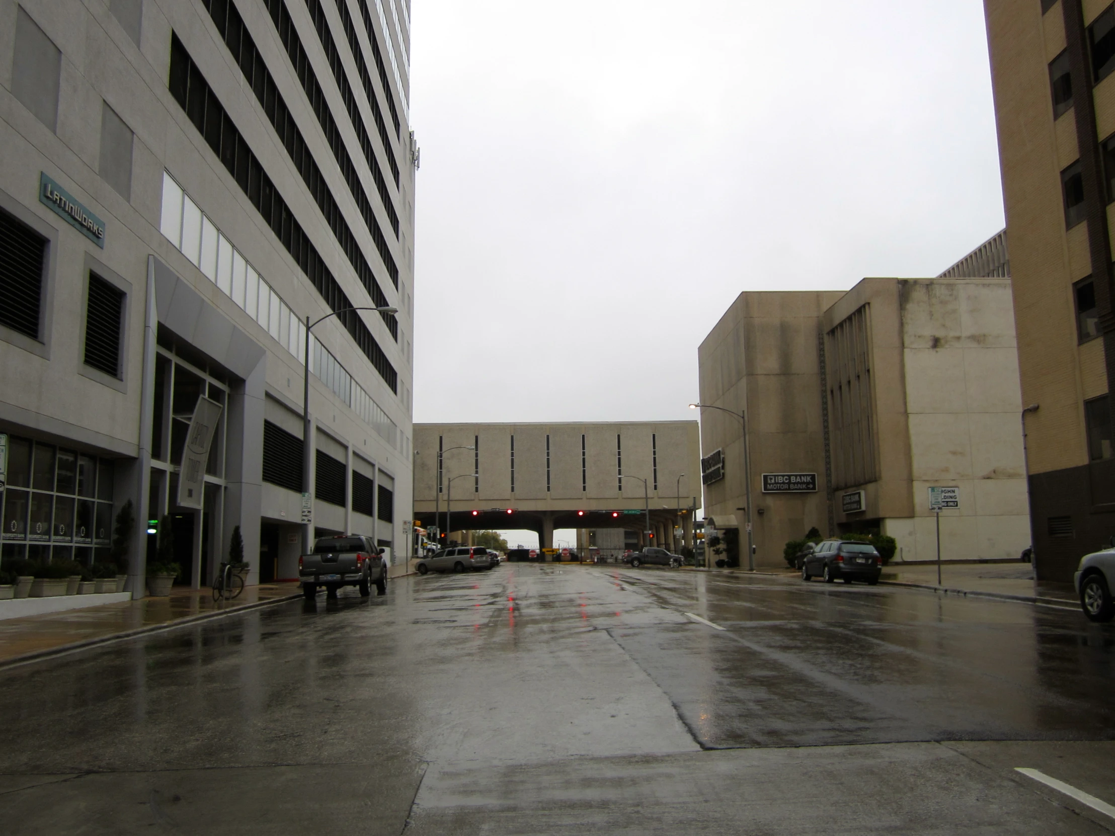 an urban street is shown on a rainy day