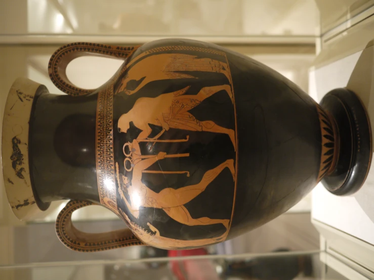 an old vase with two handles and one showing people on it