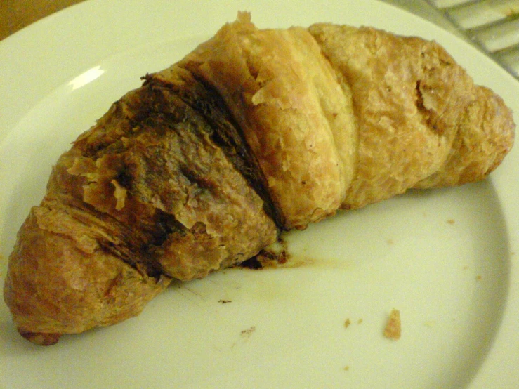 a croissant with it's cut in half on a plate