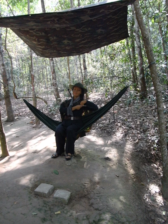 two people sitting in a hammock that has been constructed from nches