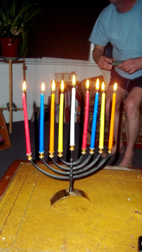 a man who is looking at a menorah