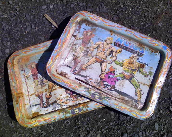 an artisticly painted serving dish that is outside on a street